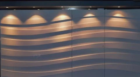 Abstract background with wave curve pattern on the wall, modern lighting syst Stock Photos