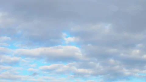 Abstract background of white fluffy clouds on a bright blue sky. Timelapse Stock Footage 140058402