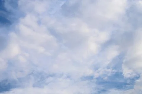Abstract background of white fluffy clouds on a bright blue sky Stock Photos