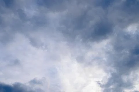 Abstract background of white fluffy clouds on a bright blue sky Stock Photos