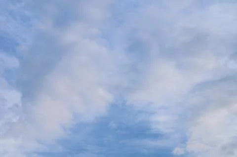 Abstract background of white fluffy clouds on a bright blue sky Stock Photos