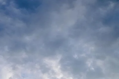Abstract background of white fluffy clouds on a bright blue sky Stock Photos
