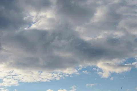 Abstract background of white fluffy clouds on a bright blue sky Stock Photos