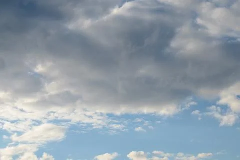 Abstract background of white fluffy clouds on a bright blue sky Stock Photos