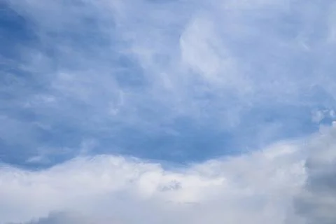 Abstract background of white fluffy clouds on a bright blue sky Stock Photos