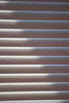 Abstract background of window blinds with sunlight filtering through the slat Stock Photos
