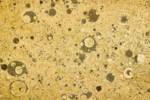 Abstract background of yellow bubbles generated in water and oil Stock Photos