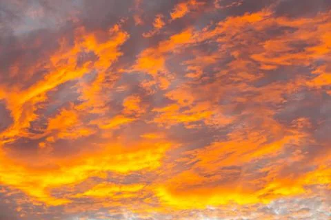 Abstract beautiful orange fluffy clouds on sunrise sky - colorful nature sky  Stock Photos