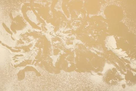 Abstract beige background with white dusting or flour. Light textured background Stock Photos