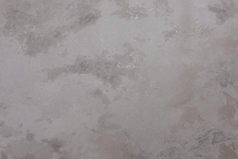 Abstract beige plaster wall texture with smooth, cloudy patterns and subtle tona Stock Photos