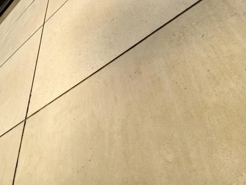 Abstract beige stone wall with diagonal panel lines 스톡 사진