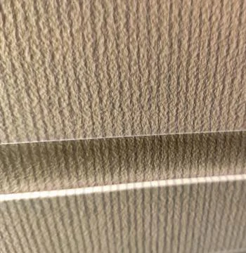 Abstract beige textured wall with diagonal light streaks Stock Photos