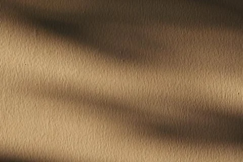 Abstract beige wall texture with soft diagonal shadows for background use. Fotos de archivo