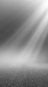 Abstract black and white background with glowing light rays shining down on.. Stock Photos