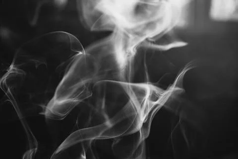 Abstract black and white macro photograph capturing wispy smoke trails in m.. Stock Photos