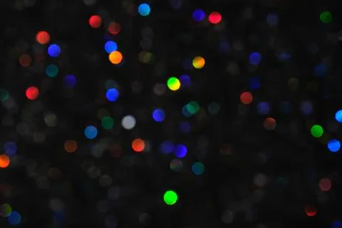 Abstract black background with bokeh of different colors. Stock Photos