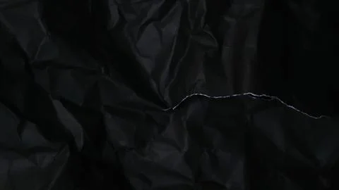 Abstract black background featuring a dark creased paper texture Stock Photos