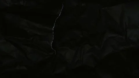 Abstract black background featuring a dark creased paper texture Stock Photos