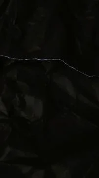 Abstract black background featuring a dark creased paper texture Stock Photos