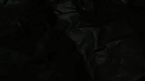 Abstract black background featuring a dark creased paper texture Stock Photos
