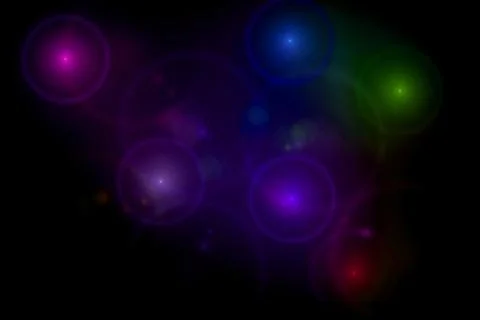 Abstract black background with multi color light flares Stock Photos