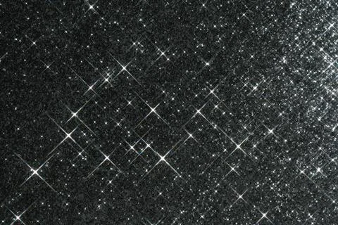 Abstract black background with sparkles in the shape of stars. Stock Photos