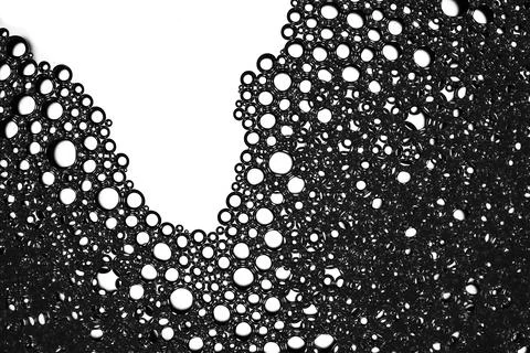 Abstract black bubbles creating a foam texture pattern Stock Photos