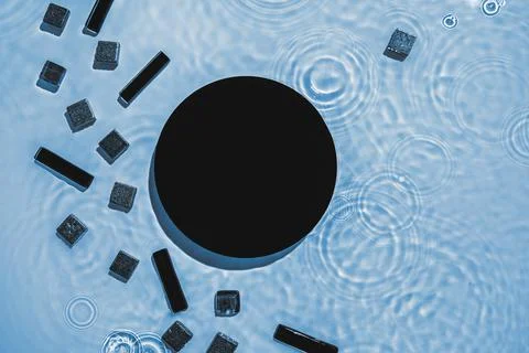 Abstract black geometric figures composition on transparent blue clear water Stock Photos