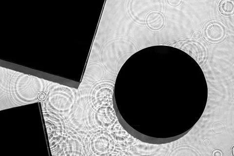 Abstract black geometric figures composition on transparent clear water Stock Photos