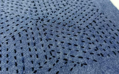 Abstract Black Sashiko Stitch Pattern on Blue Textile.  Stock Photos