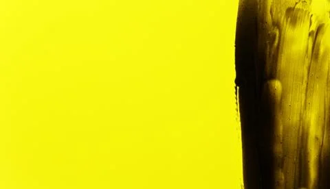 Abstract black smears (charcoal toothpaste) on yellow background, space for.. Foto stock