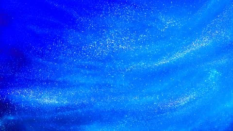Abstract blue background with tints of silver sparkles. Stock Photos