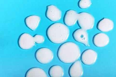 Abstract blue background with white liquid drops Stock Photos