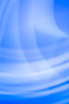 Abstract blue background with white waves. Vertical backdrop with a gradient. Stock Photos