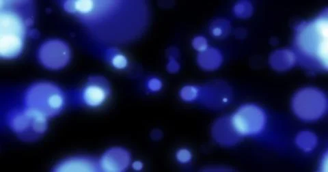 Abstract blue blurred holiday background with magical bokeh of glowing brig.. Stock Photos