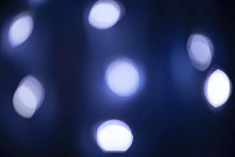 Abstract blue blurred lights in dark background Stock Photos