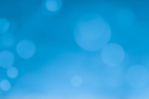Abstract blue bokeh lights background with soft gradient and glow Stock Photos