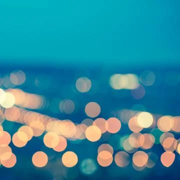 Abstract blue circular bokeh background, city lights with horizon, toned styl Stock Photos
