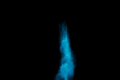 Abstract blue dust explosion on  black background. Stock Photos