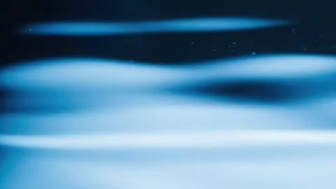 Abstract blue flowing lines in smooth motion Stock Photos