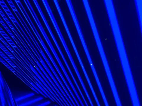 Abstract blue geometric pattern with a light source from above, possibly depi Stock Photos