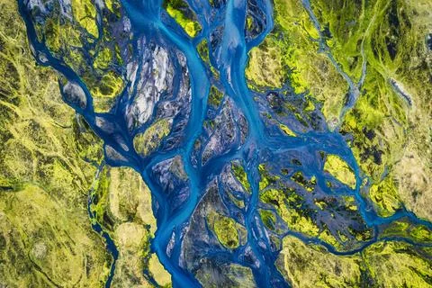 Abstract blue glacier rivers pattern flowing through volcanic moss field in.. Stock Photos
