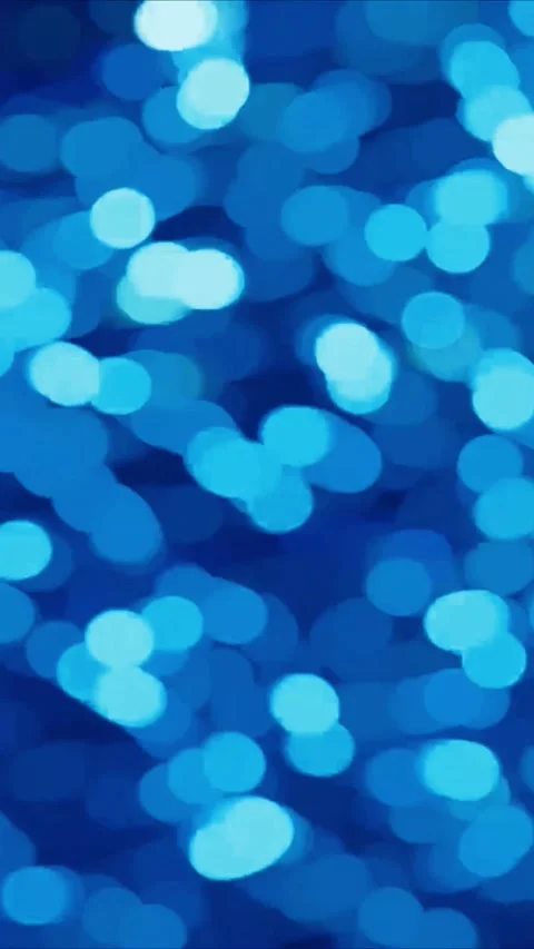 Abstract blue light bokeh background with soft glowing circles moving in a Stock Footage 347692603