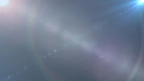 Abstract blue light flare effect with glowing lens reflections on dark Stock-Footage 346199625