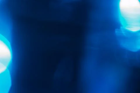 Abstract blue light leak texture background against a dark backdrop. Illustrazione stock