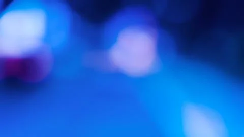 Abstract blue Light Orbs, Soft Focus Bokeh Circles on Dark Background 库存照片
