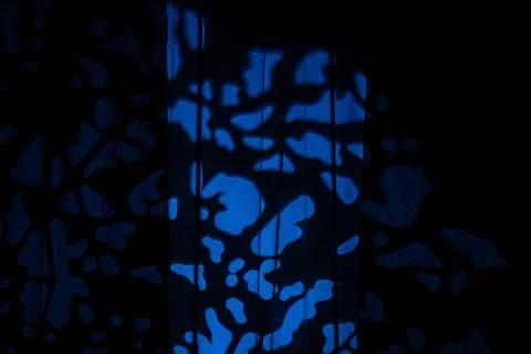 Abstract blue light pattern on dark studio curtains background Foto stock