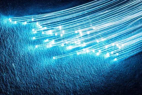 Abstract blue light trails with glowing lines and particles Stock Photos