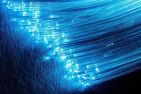 Abstract blue light waves in motion on dark background Stock Photos