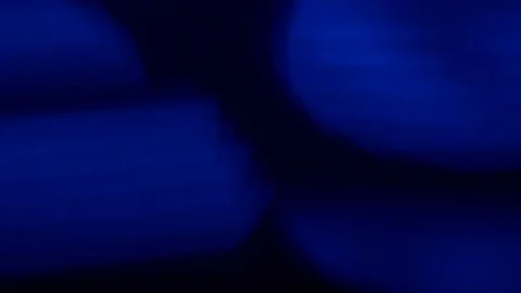 Abstract blue moving bokeh on a black background Stock Footage 73877249